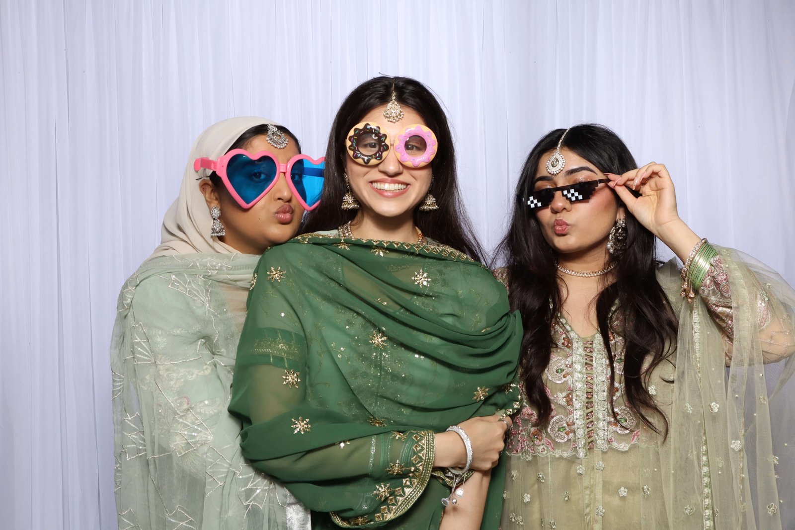 Friends having fun at a birthday party photo booth